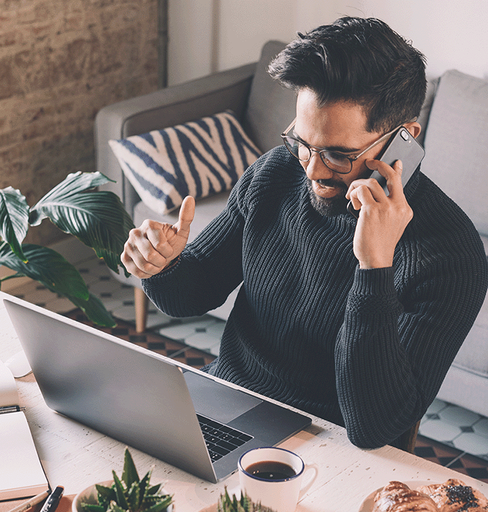 Man on Computer and Phone_1022175673_crop
